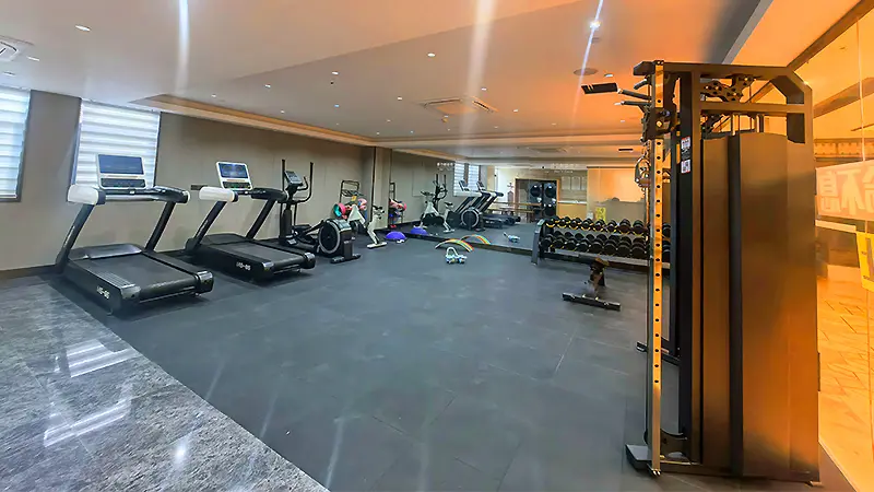Hotel gym equipment in a compact hotel fitness room