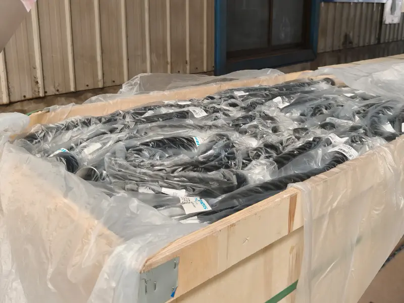 Gym equipment accessories individually packed in plastic bags inside a protective wooden shipping crate.