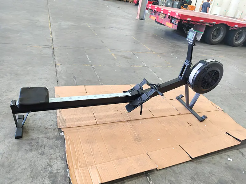 Rowing machine with sliding seat, rail and pull handle