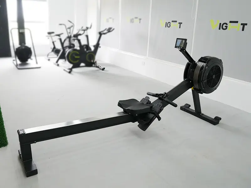 Air rowing machine with a sliding seat, footrests and display console in the VIGFIT showroom
