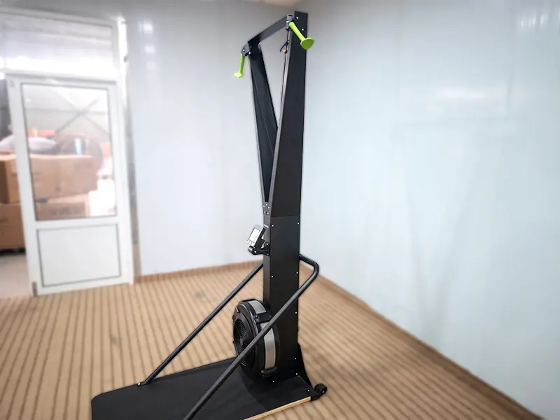 Black ski trainer with green pull handles, a display console and a freestanding floor base